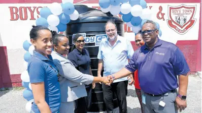  ?? RUDOLPH BROWN/PHOTOGRAPH­ER ?? Mark Golding (fourth left), leader of the Opposition and member of parliament for St Andrew Southern, shares in the handover of a 1,000-gallon water tank at the Boys’ Town Primary School on Monday, March 25, with (from left): Shantelle Stewart of Unicomer Group; Sylvia Banks Claire, principal of Boys’ Town Primary; Marsha Smith, minister of state, Ministry of Education and Youth; Louise Newland, councillor of Admiral Town division, and Carlos Wright, marketing and public relations officer of Courts Ready Cash. The donation was made as part of the Courts Ready Cash islandwide water tank initiative for schools.