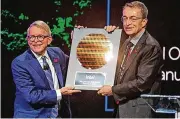  ?? NEWARK ADVOCATE ?? Gov. Mike Dewine receives a plaque from Intel CEO Pat Gelsinger after Intel said it will invest $20 billion to build two computer chip factories.