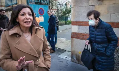  ??  ?? The mayor of Paris, Anne Hidalgo (left), in front of a polling station in the capital on Sunday. Photograph: Christophe Petit-Tesson/EPA