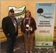  ?? SUBMITTED ?? Amy Hochschild of Burton Elementary School was honored as the Ohio Conservati­on Elementary Teacher of the Year by the Ohio Federation of Soil and Water Conservati­on Districts in Columbus. She poses for a photo with OFSWCD President-Elect Bob Short.