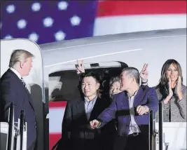  ?? Susan Walsh ?? The Associated Press President Donald Trump greets, from left, Tony Kim, Kim Hak Song and Kim Dong Chul, three Americans detained in North Korea for more than a year, as they arrive Thursday at Joint Base Andrews in Maryland. First lady Melania Trump...