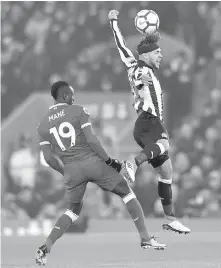  ?? THE ASSOCIATED PRESS ?? Liverpool’s Sadio Mane, left, and Newcastle United’s DeAndre Yedlin battle for the ball during their game at Anfield.