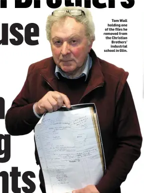  ??  ?? Tom Wall holding one of the files he removed from the Christian Brothers’ industrial school in Glin.
