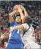  ??  ?? Kentucky’s A’dia Mathies attempts a shot over the defense of Louisville’s Bria Smith during the first half.