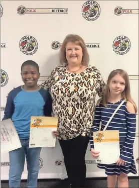  ??  ?? Zion Bradley of Rockmart Middle and Hailyn Baxter of Youngs Grove Elementary were the winner and runner-up of this year’s Spelling Bee for the Polk School District. They are pictured with Superinten­dent Laurie Atkins.