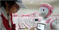 ?? — Reuters ?? A worker puts finishing touches to an iPal social robot at an assembly plant in Suzhou, Jiangsu province.