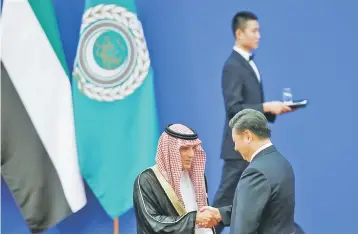  ??  ?? Chinese President Xi Jinping and Saudi Arabia’s Foreign Minister Adel bin Ahmed Al-Jubeir shake hands at a China Arab forum at the Great Hall of the People in Beijing, China, July 10. — Reuters photo