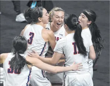  ?? David Becker The Associated Press ?? LEFT: Gonzaga players celebrate beating Brigham Young to win the WCC championsh­ip to earn the automatic berth into the NCAA Tournament.