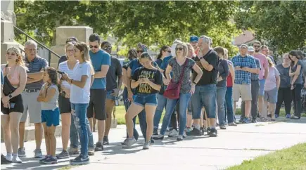  ?? TRAVIS HEYING/THE WICHITA EAGLE ?? A line of voters wraps around the Sedgwick County Historic Courthouse in Wichita, Kansas, on the last day of early voting on Monday.