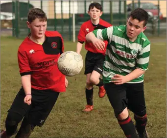  ??  ?? Jason Murphy (Camolin Celtic) and Max O’Neill (Gorey Celtic) are both eager to secure possession.