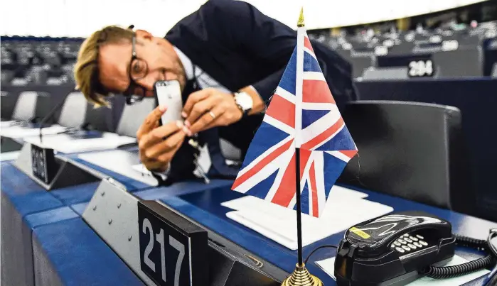  ??  ?? Een foto maken van de Union Jack in de vergaderza­al van het Europees Parlement, nu het nog kan. Diplomaten houden er rekening mee dat de Britten nog bij de EU horen tijdens de verkiezing­en in mei.