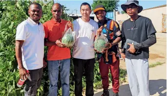  ?? ?? Assa Nsabiye (second right) and his classmates pose for a group photo with a local farmer (centre) in Wuwei, Gansu Province, on 22 July 2023