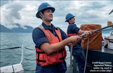  ??  ?? Coast Guard James Appledorn hoist a zodiac rig, used to check on cruise ships