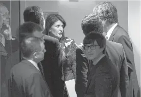  ?? AP Photo/Craig Ruttle ?? ■ U.S. Ambassador to the United Nations Nikki Haley, center, confers with members of the United Nations Security Council on Saturday just outside the chamber before a scheduled vote on a resolution demanding a 30-day humanitari­an cease-fire across Syria.