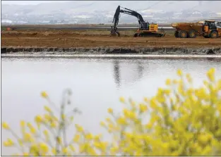  ?? ?? Constructi­on equipment for the South San Francisco Bay Shoreline Project is photograph­ed along Pond A12at Alviso Marina County Park on April 14 in San Jose. Phase 1of the flood control project is scheduled to be completed in January 2024.