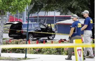  ?? CLIFF OWEN / ASSOCIATED PRESS ?? An SUV, with a bullet hole in the windshield and a flat tire, sits in the parking lot at the scene of a shooting Wednesday at a Republican congressio­nal baseball practice in Alexandria, Va.
