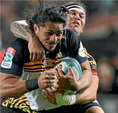  ?? PHOTOSPORT, GETTY ?? Pete Samu makes one of his familiar blockbusti­ng runs for the Brumbies during their 38-28 win over the Chiefs in Hamilton. Inset: Quinn Tupaea impressed in his return to a midfield role for the Chiefs.