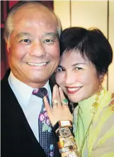  ??  ?? Recently deceased architect Geoffrey Lau enlivened a charity auction by buying seven celebrity-owned watches and draping them in wife Sandra’s arm.