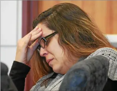  ?? ERIC BONZAR — THE MORNING JOURNAL ?? Nicole Villegas holds her head in her hand and closes her eyes as crime scene photos of Lamar Capers’ body are shown during testimony in her alleged murder trial April 26. The 34-year-old Elyria woman is on trial for the 2014 shooting death of Capers,...