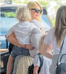  ??  ?? Holly Willoughby holds Chester, four, as they head home