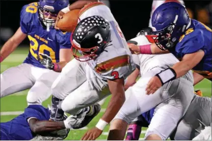  ?? BOB RAINES — DIGITAL FIRST MEDIA ?? Upper Dublin’s Malik Bootman is brought down by Upper Moreland’s Sterlen Barr and Brett Broderick Friday night.