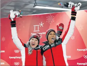  ?? THE CANADIAN PRESS/JONATHAN HAYWARD ?? Canada’s Kaillie Humphries and Phylicia George celebrate their bronze medal following women’s bobsled at the Olympic sliding centre during the 2018 Winter Olympic Games in Pyeongchan­g, South Korea, Wednesday..