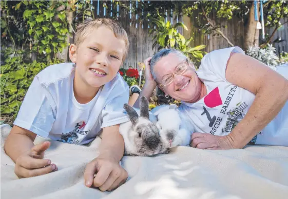  ?? Picture: JERAD WILLIAMS ?? Jett Treloar, 8, and Anna Nikolic with her rabbits Chopper and Milly. Ms Nikolic moved interstate to be able to keep her pets.