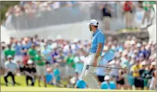  ?? Eric Gay / The Associated Press ?? Dustin Johnson reacts as he misses a putt on the sixth hole Sunday in the final round of the Match Play tournament in Austin, Texas. Johnson went on to win.