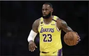  ?? AP FILE ?? LeBron James of the Lakers dribbles during the first half of an NBA game against the Brooklyn Nets in Los Angeles on March 10, 2020.