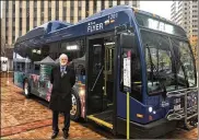  ?? CORNELIUS FROLIK / STAFF ?? Mark Donaghy, Greater Dayton RTA CEO, stands next to the Flyer, a free downtown shuttle bus.