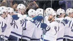  ?? RICHARD LAUTENS TORONTO STAR ?? Jake Muzzin, getting fist bumps from the Leafs’ bench, capped a three-goal second period that also included markers from John Tavares and Andreas Johnsson.