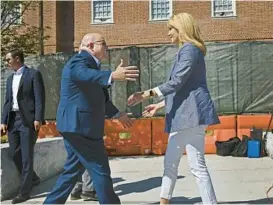  ?? KENNETH K. LAM/BALTIMORE SUN ?? Kelly Schulz, right, greets Maryland Gov. Larry Hogan before her news conference June 30 in Annapolis. Schulz placed second in the Republican primary in a bid to replace Hogan, who supported her bid.