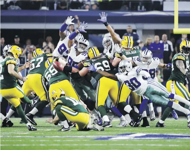  ?? JOE ROBBINS / GETTY IMAGES ?? Mason Crosby of the Green Bay Packers kicks a field goal to beat the Dallas Cowboys 34-31 in the NFC Divisional Playoff Game at AT&T Stadium on Sunday in Arlington, Tex. With three seconds left, Crosby drilled his second long field goal, this one from...