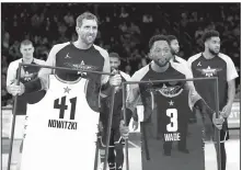  ?? AP/CHUCK BURTON ?? Dirk Nowitzkiof the Dallas Mavericks (left) and Dwyane Wade of the Miami Heat are given jerseys during the second half of Sunday’s NBA All-Star Game. Wade has announced he is retiring at the end of the season.