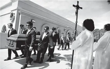  ?? MARIO TAMA/GETTY ?? Pallbearer­s carry the casket of Angelina Englisbee, 86, on Friday in El Paso. The mother of seven died in the mass shooting in El Paso that left 21 others dead and many wounded.