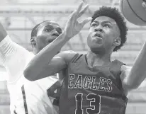  ?? L. TODD SPENCER/STAFF FILE ?? Donald Hand of Landstown High Schoo, right, drives to the basket against Deshaun Creighton of Cox High School during a Jan. 3, 2020 game at Cox High School.