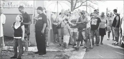  ?? ERIKA P. RODRIGUEZ / THE NEW YORK TIMES ?? People in San Isidro, Puerto Rico, wait in line for water and food on Oct. 2, 2017, 12 days after Hurricane Maria. The Federal Emergency Management Agency terminated a big contract with a tiny vendor hired to produce meals for Puerto Rico after Hurricane Maria. The awarding and subsequent cancellati­on of the contract has gained the attention of some members of Congress.