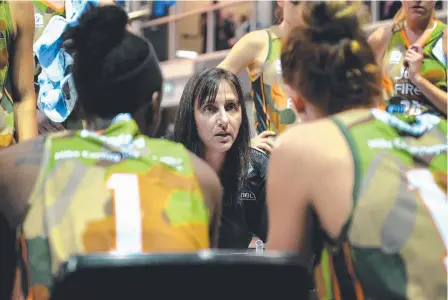  ?? HATCHING PLAN: Townsville Fire coach Claudia Brassard in a huddle with her charges. Picture: ALIX SWEENEY ??