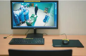  ?? CHANG W. LEE/THE NEW YORK TIMES ?? A closed-circuit TV feed shows Dr. Choi Sang-wook, second from left, the director of Kookmin Hospital, during surgery May 3 in Namyangju-si, South Korea. Cameras have “helped us win our community’s trust,” he says.