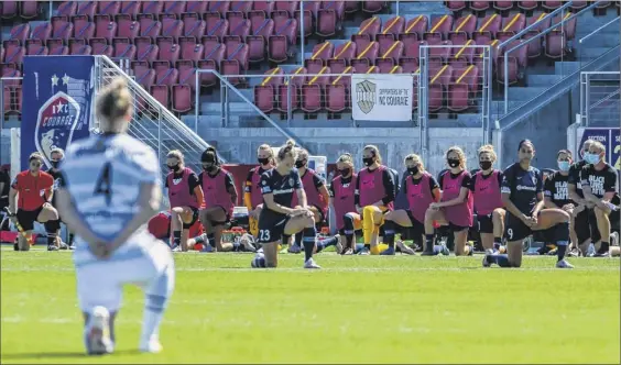  ?? Alex Goodlett / Getty Images ?? Players from the North Carolina Courage and Portland Thorns kneel during the national anthem out of respect for the Black Lives Matter movement on Saturday during the first round of the National Women’s Soccer League Challenge Cup Tournament at Zions Bank Stadium in Herriman, Utah.