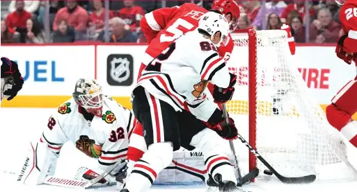  ?? PAUL SANCYA/AP ?? Blackhawks goalie Alex Stalock, who made 37 saves, stops a shot by the Red Wings’ David Perron in the second period Wednesday in Detroit.