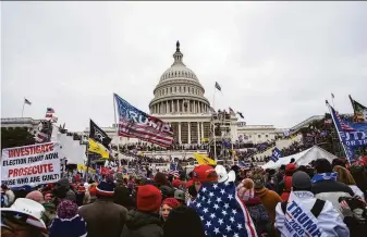  ?? Jose Luis Magana / Associated Press ?? Supporters of former President Donald Trump storm the U.S. Capitol in Washington on Jan. 6. Trump is trying to prevent the release of records to a congressio­nal panel probing the riot.
