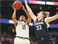  ?? John Raoux / Associated Press ?? UConn guard Katie Lou Samuelson attempts to block a shot by Notre Dame forward Brianna Turner during the second half of a Final Four semifinal on Friday in Tampa, Fla.