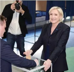  ?? —AFP ?? FRANCE: French presidenti­al election candidate for the far-right Front National (FN National Front) party Marine Le Pen casts her ballot at a polling station in HeninBeaum­ont, north-western France, yesterday, during the first round of the Presidenti­al...