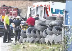  ?? The Sentinel-Record/Grace Brown ?? SHOOTING SCENE: LifeNet and other emergency personnel load an unidentifi­ed shooting victim into the back of an ambulance at Tire Express, 635 E. Grand Ave., on Monday. One witness on scene said it sounded as if the shooter “unloaded an entire clip.”