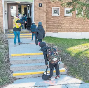  ?? RYAN REMIORZ THE CANADIAN PRESS FILE PHOTO ?? Social distancing and masks will be essential to safely reopening schools across Canada.