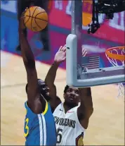  ?? GERALD HERBERT — THE ASSOCIATED PRESS ?? Draymond Green goes up for a slam dunk over the Pelicans’ Eric Bledsoe in the first half of the Warriors’ win in New Orleans on Monday night.