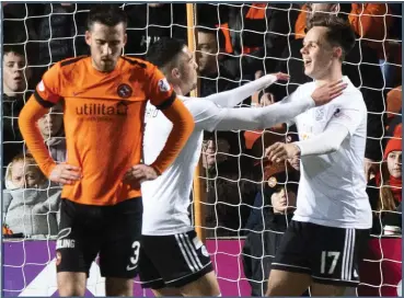  ??  ?? Lawrence Shankland (right) celebrates his second goal on his way to four at Tannadice