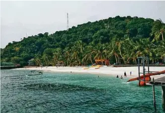  ??  ?? The white sandy beach and pristine waters provide an idyllic landscape