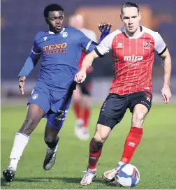  ?? Pictures: Jacques Feeney/ Getty Images ?? Chris Hussey battling for possession with Colchester’s Kwame Poku